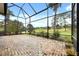 Spacious screened porch with a brick patio and golf course view at 39539 Harbor Hills Blvd, Lady Lake, FL 32159