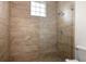 Large shower with glass enclosure and beige tile at 39539 Harbor Hills Blvd, Lady Lake, FL 32159