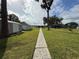 Spacious backyard with a shed and a walkway leading to the house at 4060 Lake Marianna Dr, Winter Haven, FL 33881