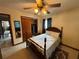 Bedroom with wooden four-poster bed, ceiling fan, and ample closet space at 4060 Lake Marianna Dr, Winter Haven, FL 33881