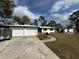 Front exterior of a single-story home with a two-car garage and driveway at 4060 Lake Marianna Dr, Winter Haven, FL 33881