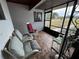 Screened-in sunroom or porch with rocking chairs and tiled flooring at 4060 Lake Marianna Dr, Winter Haven, FL 33881