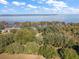 Aerial view of waterfront property with lush landscape at 5415 Banana Point Dr, Okahumpka, FL 34762