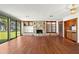 Gathering room with stone fireplace, built-in shelving, and water views at 5415 Banana Point Dr, Okahumpka, FL 34762