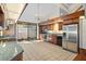 Kitchen with dark wood cabinets, granite counters, and stainless steel appliances at 5415 Banana Point Dr, Okahumpka, FL 34762