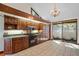Kitchen boasts dark wood cabinets, granite countertops and a view to outside at 5415 Banana Point Dr, Okahumpka, FL 34762