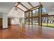 Spacious living room with hardwood floors, vaulted ceilings, and large windows offering scenic views at 5415 Banana Point Dr, Okahumpka, FL 34762