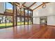 Bright living room with hardwood floors, large windows, and water views at 5415 Banana Point Dr, Okahumpka, FL 34762