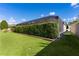Landscaped backyard with screened enclosure and lush greenery at 747 Bradford Loop, The Villages, FL 32163