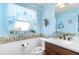 Bright bathroom with decorative wallpaper and updated fixtures at 747 Bradford Loop, The Villages, FL 32163