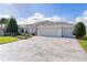 Spacious home with a three-car garage and nicely landscaped front yard at 747 Bradford Loop, The Villages, FL 32163