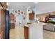 Modern kitchen with wood cabinets, black appliances, and a breakfast bar at 747 Bradford Loop, The Villages, FL 32163