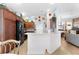 Modern kitchen with wood cabinets, black appliances, and a breakfast bar at 747 Bradford Loop, The Villages, FL 32163
