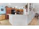 Modern kitchen with wood cabinets, black appliances, and a breakfast bar at 747 Bradford Loop, The Villages, FL 32163