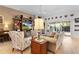 Bright living room features hardwood floors, comfy seating, and a large entertainment center at 747 Bradford Loop, The Villages, FL 32163