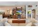 Spacious living room with built-in shelving, hardwood floors, and a cozy fireplace at 747 Bradford Loop, The Villages, FL 32163