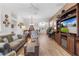 Open concept living room with hardwood floors, a dining area, and views to kitchen at 747 Bradford Loop, The Villages, FL 32163