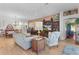 Open living room showcasing hardwood floors, ample seating, and views to dining area at 747 Bradford Loop, The Villages, FL 32163