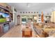 Comfortable living room featuring a large TV, fireplace and access to pool at 747 Bradford Loop, The Villages, FL 32163