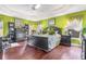 Bright main bedroom with hardwood floors, large bed, and built-in workspace at 747 Bradford Loop, The Villages, FL 32163