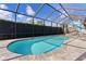 Inviting kidney-shaped pool with screened enclosure at 747 Bradford Loop, The Villages, FL 32163