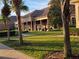 Exterior view of the community clubhouse surrounded by manicured landscaping at 79 Bayou Bend Rd, Groveland, FL 34736