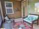 Cozy screened porch with wicker furniture and colorful rug at 79 Bayou Bend Rd, Groveland, FL 34736