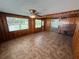 Living room with wood paneling, tiled floors, ceiling fan, and piano at 8 S Solandra Dr, Orlando, FL 32807