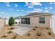 Backyard with a patio, landscaping, and a white fence at 867 Parrish Pl, The Villages, FL 32163