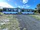 Newly constructed mobile home exterior, featuring green siding and black window frames at 9018 Atlas Dr, Saint Cloud, FL 34773