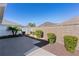 Landscaped backyard with a concrete patio and privacy wall at 9189 Se 167Th Dandrea Pl, The Villages, FL 32162