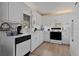 Clean white kitchen with modern appliances and ample counter space at 950 Beaver Run, Tavares, FL 32778