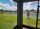 Screened patio with view of a pond and neighboring houses at 964 Rivers Crossing St, Clermont, FL 34714