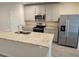 Modern kitchen featuring stainless steel appliances, ample counter space, and stylish cabinetry at 964 Rivers Crossing St, Clermont, FL 34714