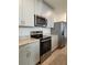 Well-equipped kitchen with sleek appliances, light gray cabinets, and wood-look tile flooring at 964 Rivers Crossing St, Clermont, FL 34714