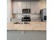 Kitchen island with granite countertops, stainless steel appliances, and a double sink at 964 Rivers Crossing St, Clermont, FL 34714