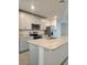 Spacious kitchen with an island, modern appliances, and gray shaker cabinets at 964 Rivers Crossing St, Clermont, FL 34714