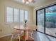 Kitchen breakfast nook with patio access and a round wooden table at 102 Cedar Way, Yalaha, FL 34797