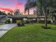 Single-story home with landscaped yard and attached garage at 102 Cedar Way, Yalaha, FL 34797