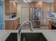 Modern kitchen sink and faucet with quartz countertops at 102 Cedar Way, Yalaha, FL 34797