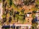 Aerial view showing house and large lot with mature trees at 11451 Pala Verda Ave, Leesburg, FL 34788