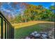 Fenced backyard with a grassy area and trees at 11451 Pala Verda Ave, Leesburg, FL 34788