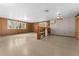 Spacious basement with wood paneling, built-in shelving and large windows at 11451 Pala Verda Ave, Leesburg, FL 34788
