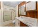 Full bathroom with shower/tub, vanity, and wood accents at 11451 Pala Verda Ave, Leesburg, FL 34788