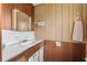 Simple bathroom with shower/tub combo and wood-paneled walls at 11451 Pala Verda Ave, Leesburg, FL 34788
