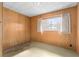 Simple bedroom with wood paneled walls and carpeted floor at 11451 Pala Verda Ave, Leesburg, FL 34788