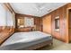 Cozy bedroom with wood paneling and a double bed at 11451 Pala Verda Ave, Leesburg, FL 34788