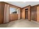 Small bedroom featuring wood paneling and a window at 11451 Pala Verda Ave, Leesburg, FL 34788