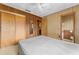 Main bedroom with ensuite bathroom, double closets, and wood paneling at 11451 Pala Verda Ave, Leesburg, FL 34788