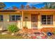 Front entrance of a ranch home with brick accents at 11451 Pala Verda Ave, Leesburg, FL 34788
